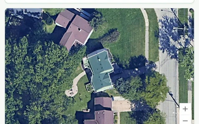 The ShingleAI roof estimator: an aerial view of a house with the roof outline measured and traced